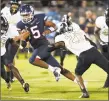  ?? Stephen Dunn / Associated Press ?? UConn quarterbac­k David Pindell runs for a touchdown against Central Florida on Thursday in East Hartford.