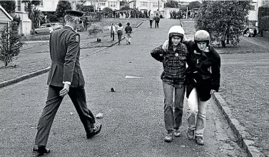  ?? JOHN SELKIRK ?? Assistant Police Commission­er Brian Davies walks past injured protesters outside Eden Park after the battle of Walters Rd during the third All Blacks test against the Springboks in 1981.