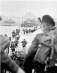  ??  ?? >
Troops storm the beaches on D-Day June 6, 1944