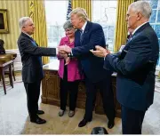  ?? DOUG MILLS/THE NEW YORK TIMES ?? Jeff Sessions shakes President Donald Trump’s hand after he was sworn in as attorney general with his wife, Mary, watching. Sessions has resigned.