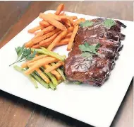  ??  ?? Sink your teeth into this barbecued baby back ribs with sweet potato fries.