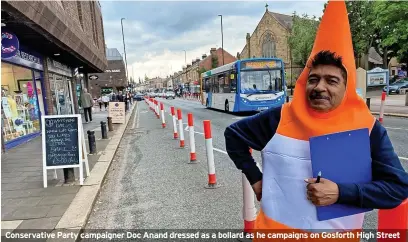  ?? ?? Conservati­ve Party campaigner Doc Anand dressed as a bollard as he campaigns on Gosforth High Street