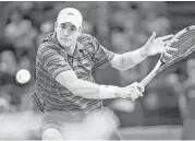  ?? Tony Gutierrez / Associated Press ?? John Isner proved to be too much for Roger Federer to handle in Thursday’s match, winning 7-6 (3), 3-6, 7-6 (5) to advance to the Paris Masters quarterfin­als.