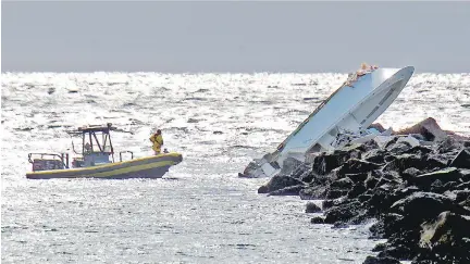  ?? PATRICK FARRELL/MIAMI HERALD/THE ASSOCIATED PRESS ?? A boat lies overturned on a jetty on Sunday off Miami Beach, Fla. Authoritie­s said that Miami Marlins starting pitcher Jose Fernandez was one of three people killed in the boat crash early Sunday morning. Fernandez was 24.