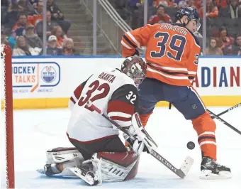  ?? JASON FRANSON/THE CANADIAN PRESS VIA AP ?? Coyotes goalie Antti Raanta (32) makes the save as the Oilers' Alex Chiasson (39) screens him during second period action in Edmonton, Alberta, on Saturday.