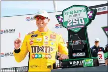  ??  ?? Kyle Busch celebrates in Victory Lane after wining a NASCAR Xfinity Series auto race, on July 10, in Hampton, Ga. (AP)