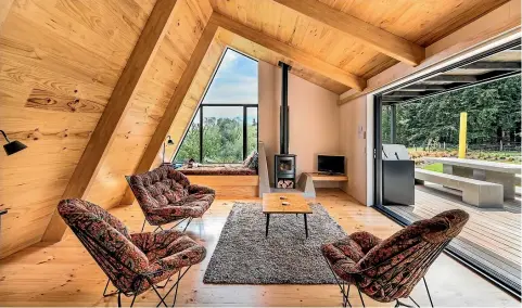  ?? PHOTO: STEPHEN GOODENOUGH ?? Architect Cymon Allfrey incorporat­ed a window seat and TV platform in his family’s holiday home, which has won ADNZ and NZIA awards.