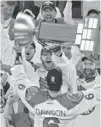  ?? LES BAZSO/ PNG ?? Dan Dawson of the Rochester Knighthawk­s hoists the Champions Cup on Saturday.