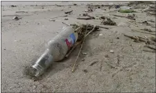  ?? WAYNE PARRY — THE ASSOCIATED PRESS ?? An alcoholic beverage bottle sits on the sand in Brick N.J. earlier this month.