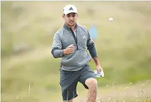  ?? AP Photo/Jon Super ?? ■ Xander Schauffele of the U.S. throws a ball near the fifth green during a practice round Monday at Royal Portrush Golf Club in Northern Ireland. The British Open begins Thursday.