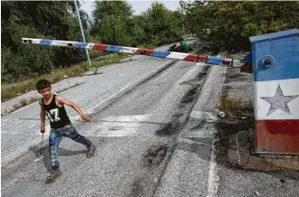  ?? Associated Press file ?? A migrant child walks past an abandoned border crossing that leads from Serbia to Hungary. Every day, millions of people cross borders unchecked in the 26-country Schengen travel zone.