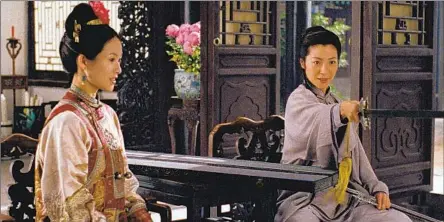 ?? Photograhs by Peter Pau Sony Pictures Classics ?? JEN YU (Zhang Ziyi, left) gets a lesson from Yu Shu Lien (Michelle Yeoh) in martial arts masterpiec­e “Crouching Tiger, Hidden Dragon.”