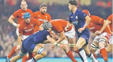  ??  ?? Wales’ flanker Dan Lydiate (centre) is tackled during the internatio­nal rugby union test match between Wales and Scotland at Principali­ty stadium in Cardiff, south Wales. — AFP photo