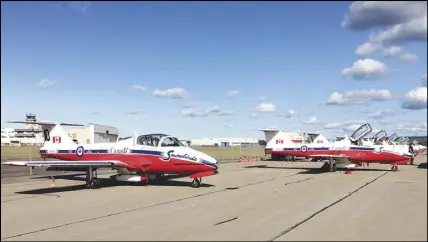  ?? CP PHOTO ?? The Snowbirds jets sit parked on the tarmac following a performanc­e at CFB Greenwood Saturday. Fire trucks responded after one of the planes flown by the Snowbird aerobatic team appeared to catch fire on the runway.