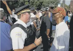  ??  ?? 0 Polic e and residents face off during protests after the shooting