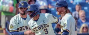  ?? ROY DABNER / FOR THE JOURNAL SENTINEL ?? The Brewers' Orlando Arcia is congratula­ted by teammates Manny Pina, left, and Ben Gamel after hitting a three-run homer.