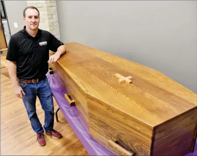  ?? STACI VANDAGRIFF/RIVER VALLEY & OZARK EDITION ?? Lucas Strack of Conway stands with the coffin he made for the St. Joseph School Bazaar in August. Strack, an architect and owner of Strack Studio Furniture, got the blueprints from the Benedictin­e monks at Subiaco Abbey. The coffin is for sale and can be seen at the St. Joseph School Endowment Office, 1315 College Ave. in Conway.