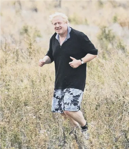  ?? PICTURE: LEON NEAL/GETTY ?? 0 Boris Johnson jogs in a field in apparent mockery of Theresa May’s ‘field of wheat’ confession