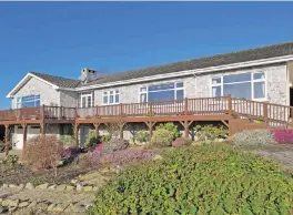  ??  ?? The house is split-level with most rooms on the upper floor. Left, the large living and dining room