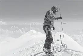  ?? Compass Data / USGS via Associated Press ?? Blaine Horner of CompassDat­a probes the snow pack on top of Denali, the highest point in North America. Denali National Park in Alaska is among the parks whose entrance fees may more than double.