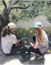  ??  ?? ‘ The children’s smiles after the mural was completed made us feel emotionall­y fulfilled,’ the two volunteers say.