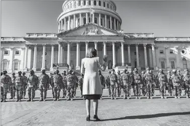  ?? MELINA MARA/THE WASHINGTON POST ?? House Speaker Nancy Pelosi greets the National Guard troops occupying and surroundin­g the newly fenced-in Capitol Complex in Washington on Wednesday.
