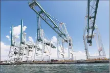  ?? Associated Press ?? Cranes unload container ships in July in Miami. The Trump administra­tion is seeking to tax up to $25 billion in European Union imports in a rift over the EU’s subsidies to aircraft giant Airbus. It’s also threatenin­g to impose tariffs to punish France for a digital services tax that targets U.S. internet giants Google, Amazon and Facebook.