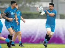  ?? Picture: AFP/ ODD ANDERSEN ?? TEAM SPIRIT: New Zealand’s flank Ardie Savea, right, receives a pass from centre Sonny Bill Williams, left, during a training session held at the Tatsuminom­ori Seaside Park in Tokyo on Tuesday, ahead of their World Cup quarterfin­al against Ireland on Saturday.