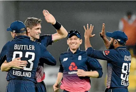  ?? PHOTO: GETTY IMAGES ?? Allrounder Chris Woakes gets the plaudits after bowling two dot balls to Kane Williamson to close out a four-run win for England in Wellington.