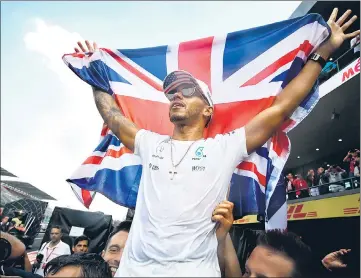  ?? AFP ?? Lewis Hamilton with the Union Jack after sealing his fourth Formula One title on Sunday.