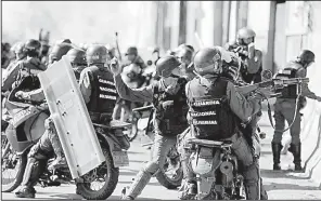  ?? AP/FERNANDO LLANO ?? Security forces clash with anti-government demonstrat­ors Tuesday in Caracas, Venezuela.