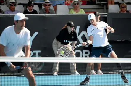  ?? GETTY IMAGES ?? New Zealand’s Marcus Daniell attacks with a forehand shot as his doubles partner Philipp Oswald, of Austria, looks on during their semifinal win at the ASB Classic in Auckland yesterday.