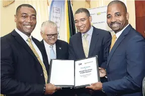  ?? RUDOLPH BROWN/PHOTOGRAPH­ER ?? Prime Minister Andrew Holness (second right) is accompanie­d by (from left) Mark Barnett, president of the NWC; Karl Samuda, minister without portfolio in the Ministry of Economic Growth and Job Creation; and Steven Gooden, CEO of NCB Capital Markets,...