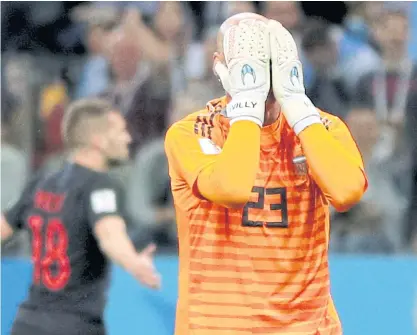  ??  ?? Argentina goalkeeper Willy Caballero reacts after Croatia’s Ante Rebic, background, scored his team’s first goal.