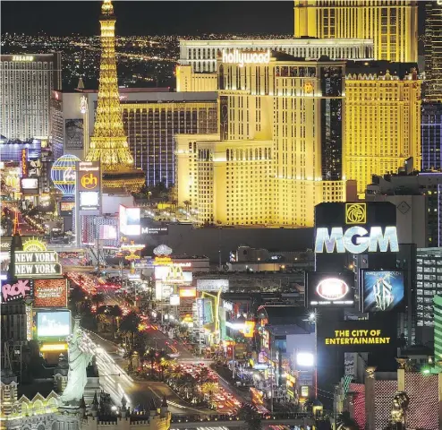  ?? ETHAN MILLER / GETTY IMAGES ?? The Las Vegas strip promises to bring a new vibe to the NHL when an expansion team is formally awarded to the city. But natives say there is so much more to Las Vegas than this amusement park for adults.