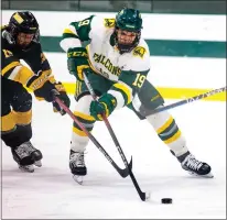  ?? GARY FOURNIER — SENTINEL & ENTERPRISE ?? Fitchburg State’s Michael Macchioni tries to move the puck past Framingham State’s Brent Scott during a Jan. 25 game.