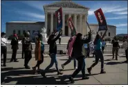  ?? (The New York Times/Anna Moneymaker) ?? Supporters of nominee Amy Coney Barrett march outside the Supreme Court building Wednesday in Washington.