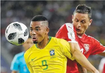  ?? THE ASSOCIATED PRESS ?? Brazil’s Gabriel Jesus, left, competes with Serbia’s Nemanja Matic for the ball during their World Cup Group E finale on Wednesday in Moscow. Brazil won 2-0 and advanced to the knockout stage to keep its hopes for a sixth tournament title intact.