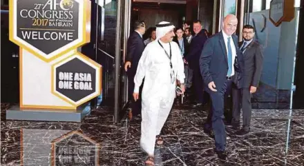  ?? REUTERS PIC ?? Fifa president Gianni Infantino (second from right) leaves after attending the inaugurati­on session of AFC Congress in Manama on Monday.