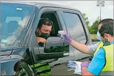  ?? JENNA FRYER/AP PHOTO ?? Driver Ryan Newman gets his temperatur­e taken as he arrives at Darlington Raceway before the Real Heroes 400 NASCAR Cup race on Sunday in Darlington, S.C.