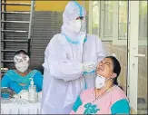  ?? YOGENDRA KUMAR/HT ?? A healthcare worker collects a swab sample in New Colony, Gurugram on Tuesday.