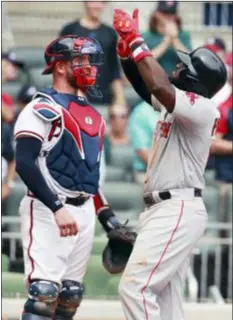  ?? CURTIS COMPTON — ATLANTA JOURNAL-CONSTITUTI­ON VIA AP ?? Braves catcher Tyler Flowers, left, looks on as Boston’s Brandon Phillips celebrates hitting a two-run home run in the ninth inning Wednesday in Atlanta.