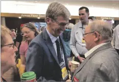  ?? AP PHOTO/STEVE KARNOWSKI ?? Republican gubernator­ial candidate Dr. Scott Jensen works the delegates to the Minnesota GOP State Convention on Saturday at the Mayo Civic Center in Rochester, Minn..