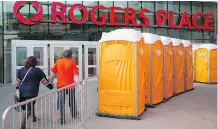  ?? DAVID BLOOM ?? Portable toilets are located outside Edmonton’s Rogers Place to accommodat­e the influx downtown during the NHL playoffs.