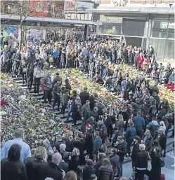  ??  ?? Chris Bevington who was killed in the Stockholm terror attack. Right, floral tributes at the scene of the tragedy.