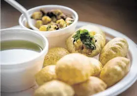  ?? Annie Mulligan / Contributo­r ?? Shayona Cafe offers pani puri and foods native to India’s Gujarat state.