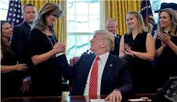  ??  ?? Trump shakes hands with Shults at the Oval Office. — Reuters photo