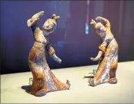  ?? PHOTOS BY JIANG DONG / CHINA DAILY AND PROVIDED TO CHINA DAILY ?? Treasures on show at the Palace Museum in Beijing include the early 12th-century masterpiec­e, A Panorama of Rivers and Mountains, and ancient clay figurines.