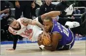  ?? AARON GASH – THE ASSOCIATED PRESS ?? Milwaukee's Khris Middleton, right, and Miami's Caleb Martin, left, fight for a loose ball during Friday's game.