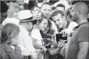  ?? Etienne Laurent European Pressphoto Agency ?? FRENCH President Emmanuel Macron, second from right, poses for a selfie near his house in Le Touquet.